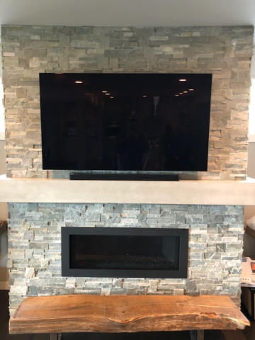 Custom Flat Panel TV Mounting & Installation in Stone Wall Over Fireplace